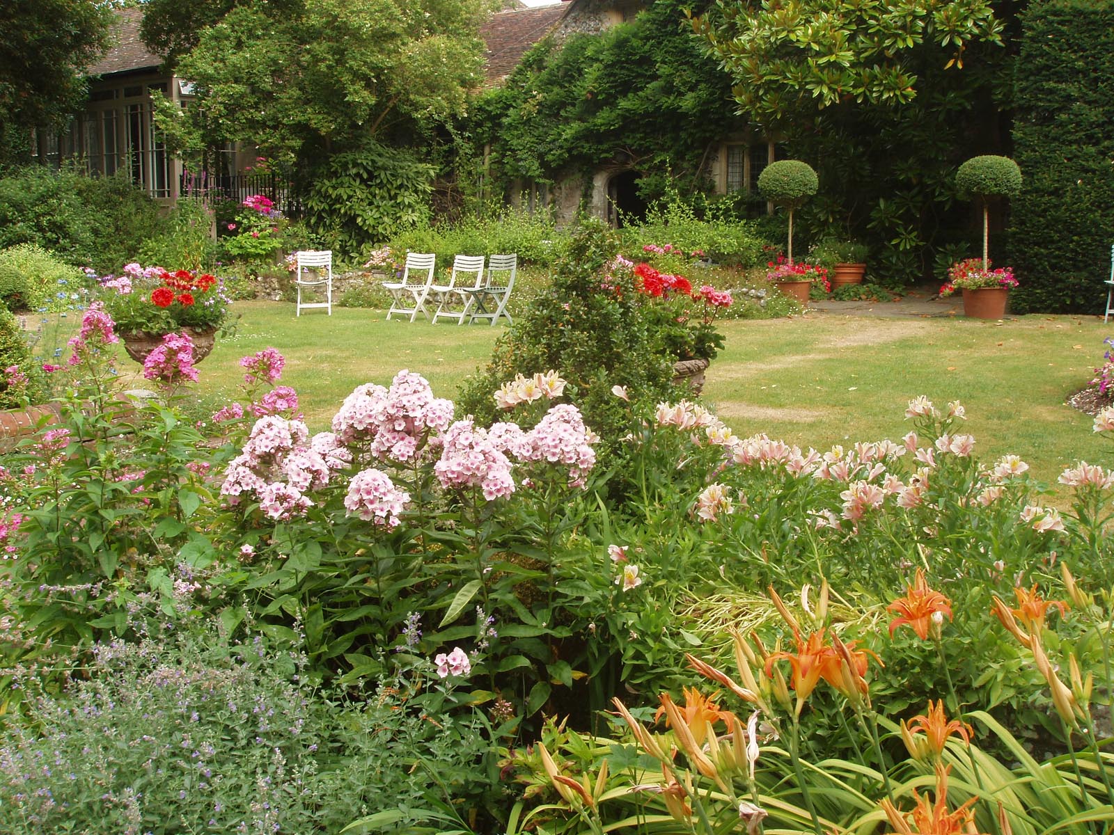 Summer borders and chairs awaiting visitors in the South Garden