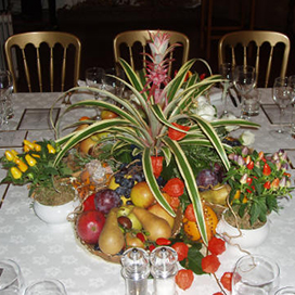 A decorated and laid table with fruit ready for a function
