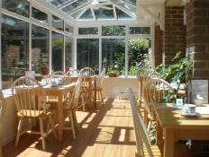 Sunny view inside the Orchard Tea room with tables ready for guests